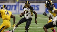 Detroit King quarterback Dequan Finn carries the ball against East English Village during the Detroit Public School League championship game at Ford Field, Friday, October 20, 2017.